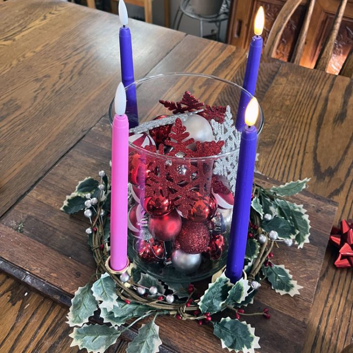 an advent wreath with two purple candles lit