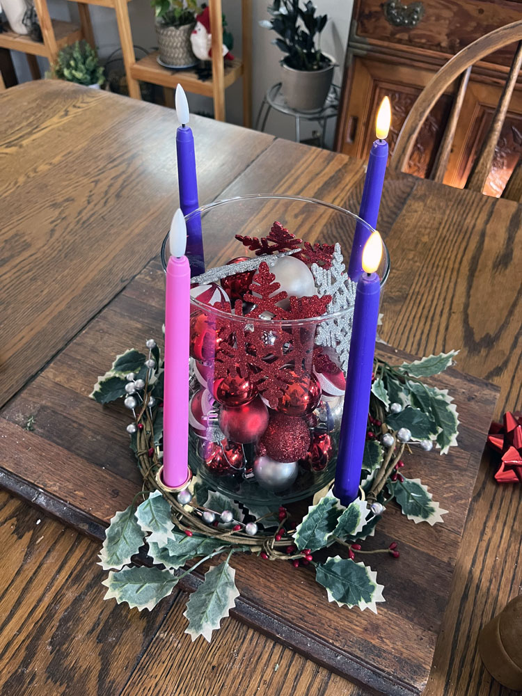 an advent wreath with two purple candles lit