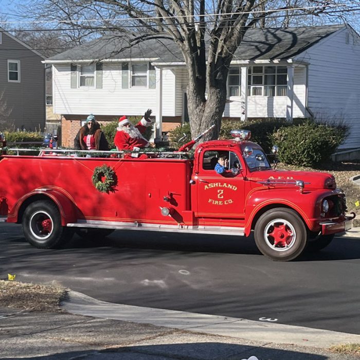 santa claus in an antique fire truck