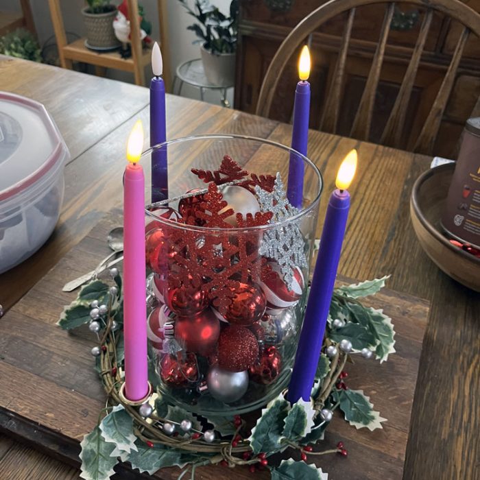 an advent wreath with two purple and one pink candle list