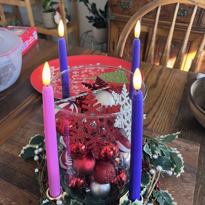 an advent wreath with all four candles lit