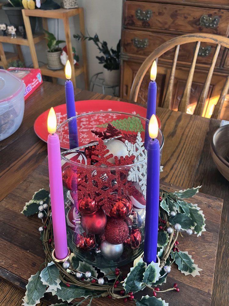 an advent wreath with all four candles lit