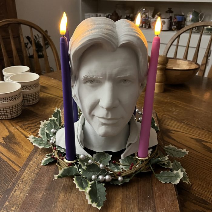 a 3d printed han solo head in the middle of a fully lit advent wreath