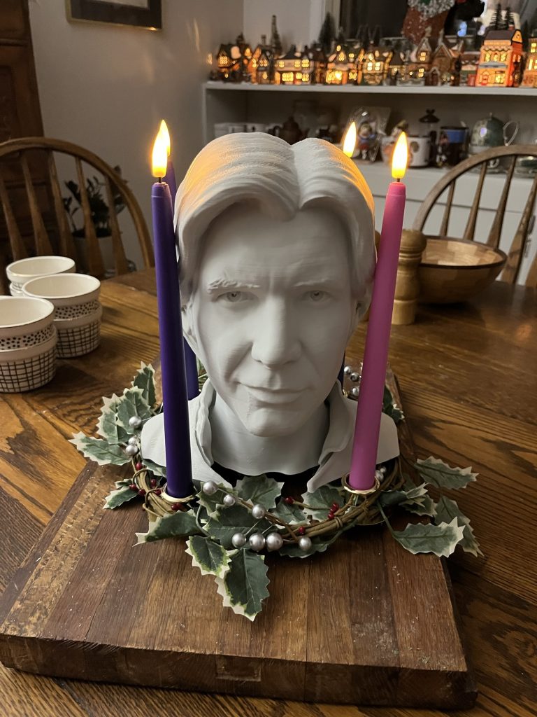 a 3d printed han solo head in the middle of a fully lit advent wreath