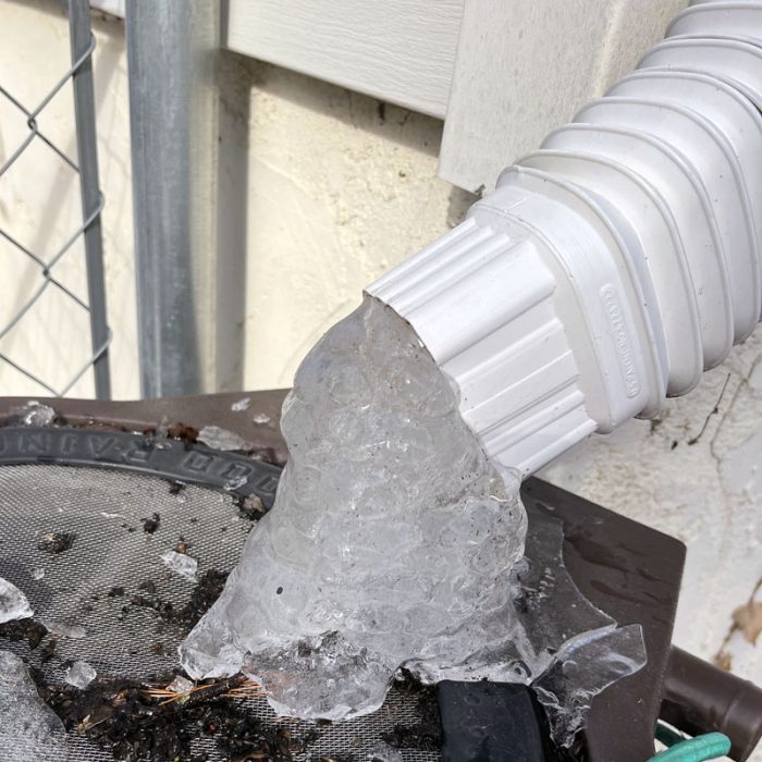 frozen water at the end of the downspout. it's been very cold