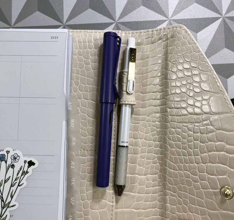 an image of the pen holder, which holds a standard pen just fine. My purple Lamy is next to it as comparison