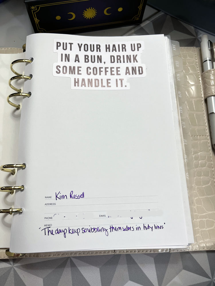 the cover page of my planner, featuring a sticker that says ' put your hair up in a bun, drink some coffee and handle it." at the bottom of the page is my name and the DMB quote "The days keep scribbling themselves in tidy lines"