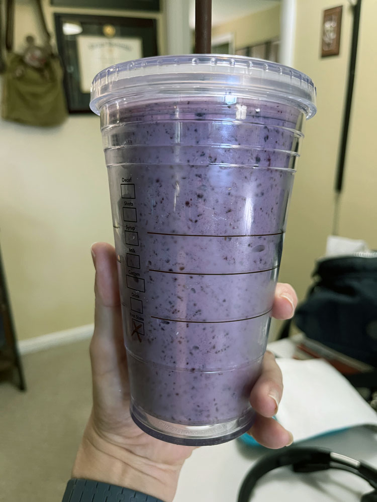 a blueberry banana smoothie in an insulated cup