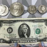Top: four coins, a 50cent piece, a dollar coin, and two quarters. Bottom: a 2 dollar bill. All are from the 1976 bicentennial series.