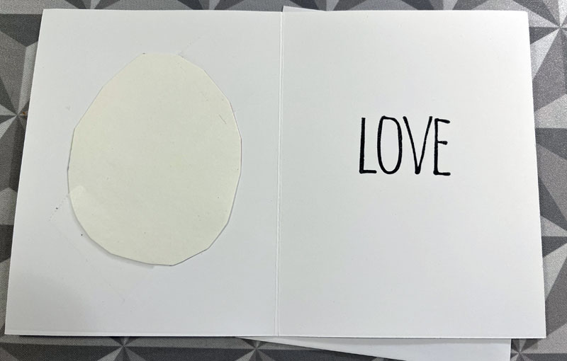 the inside of the card, with the taped insert on the left and LOVE stamped on the right