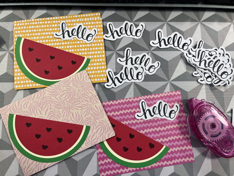 watermelon card fronts, a pile of hello greetings, and a tape roller