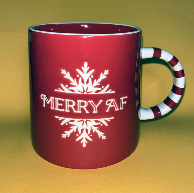 a red mug with a white snowflake on it. It also says MERRY AF.