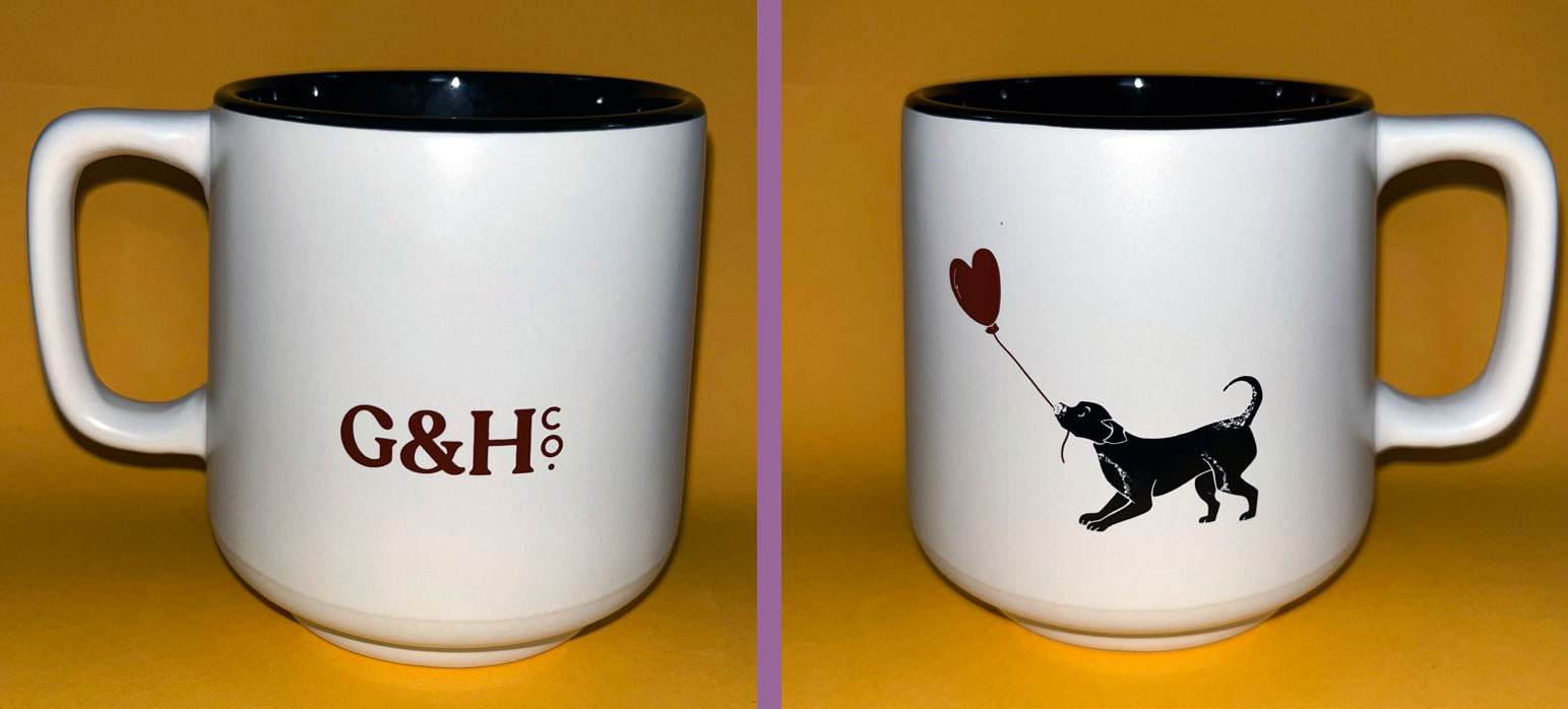 two sides of the grounds & hounds mug; the left photo shows the G&H logo, the right photo has an image of a little black dog holding a heart balloon.