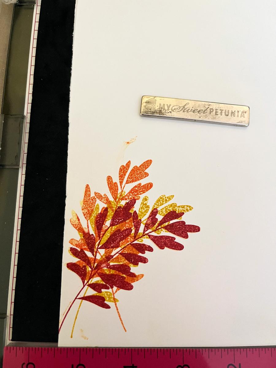 three fronds stamped on top of each other in red, orange, and yellow. it looks bad.
