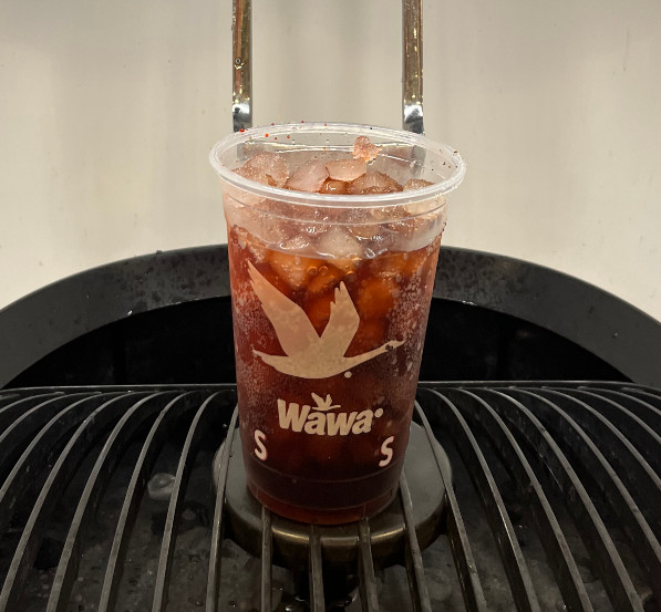 a small plastic Wawa branded cup filled with red cola