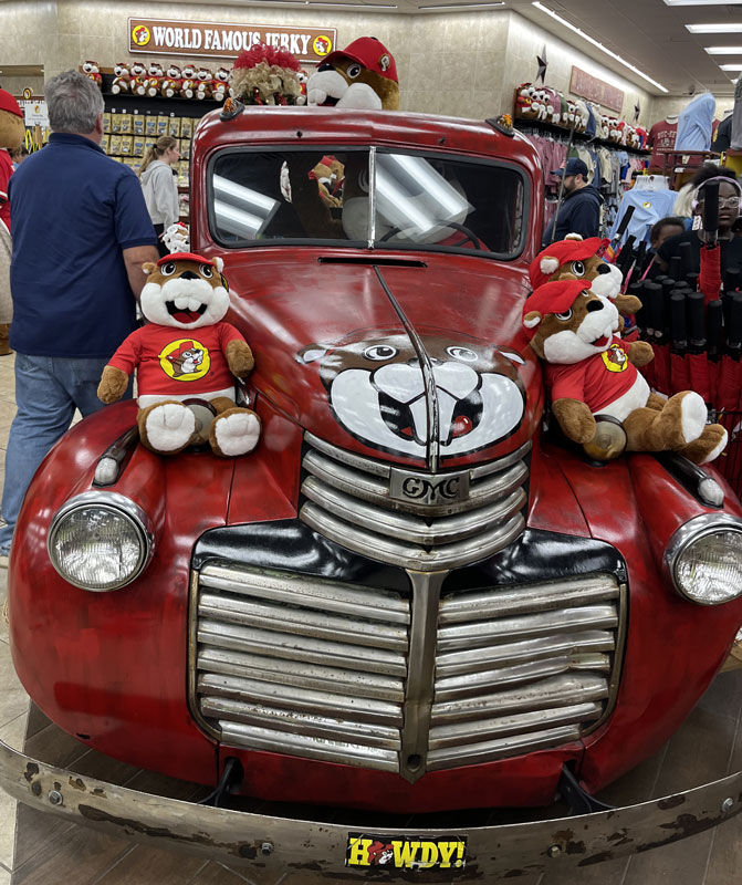 an antique red truck with Buc-ee's merch on it
