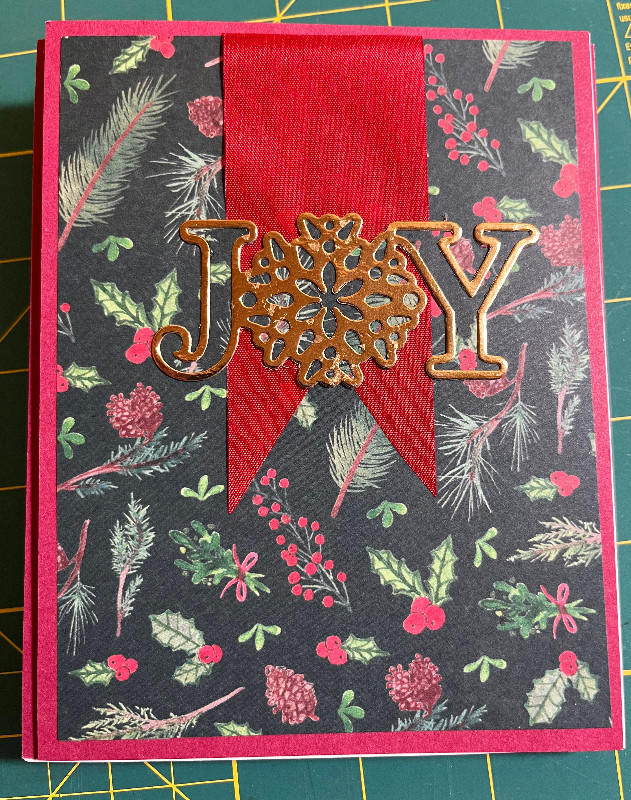portrait orientation card, red ribbon, black paper w/red and green images, nad a gold JOY