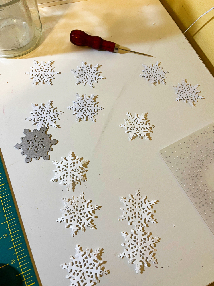 many white snowflakes and an awl