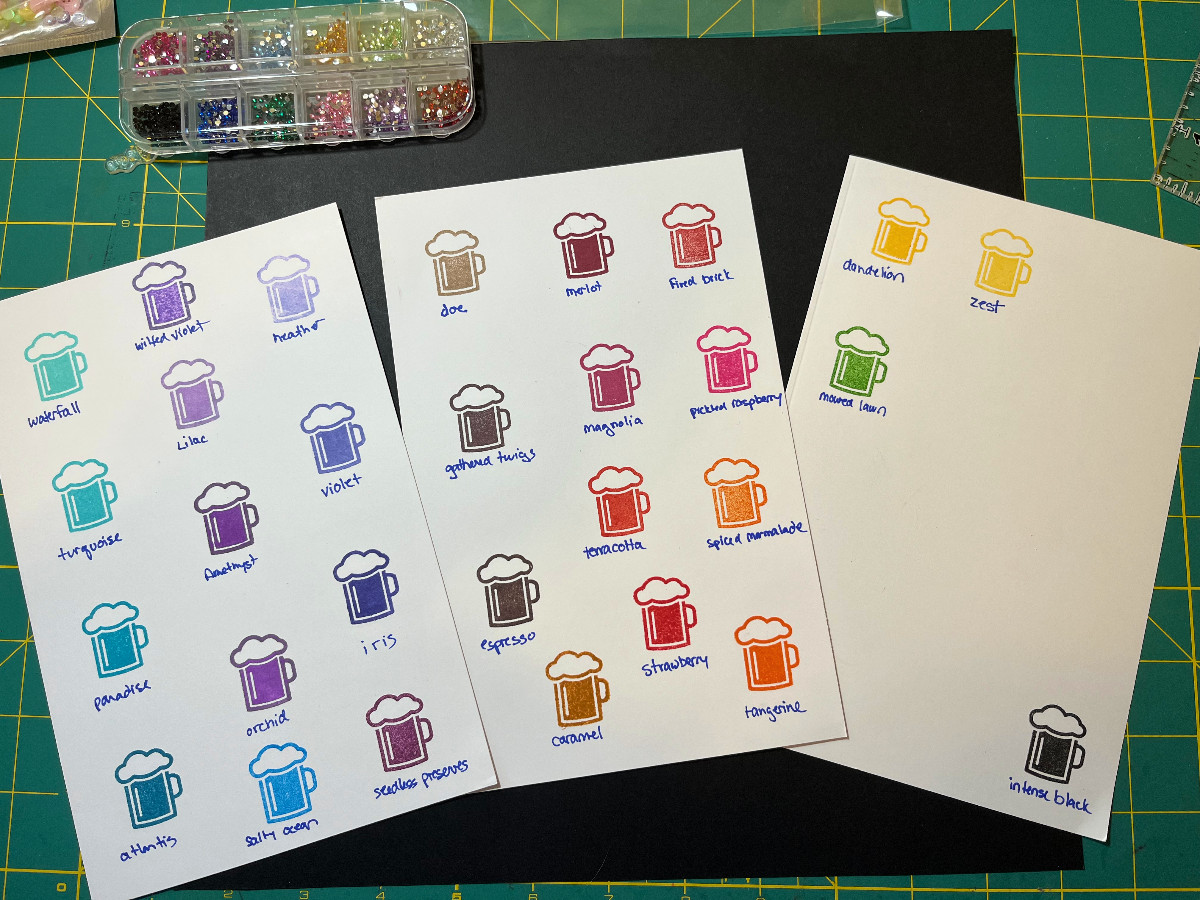 ink swatching: three sheets of cardstock with stamped beer mugs in various colors, the ink color names are written below each stamp