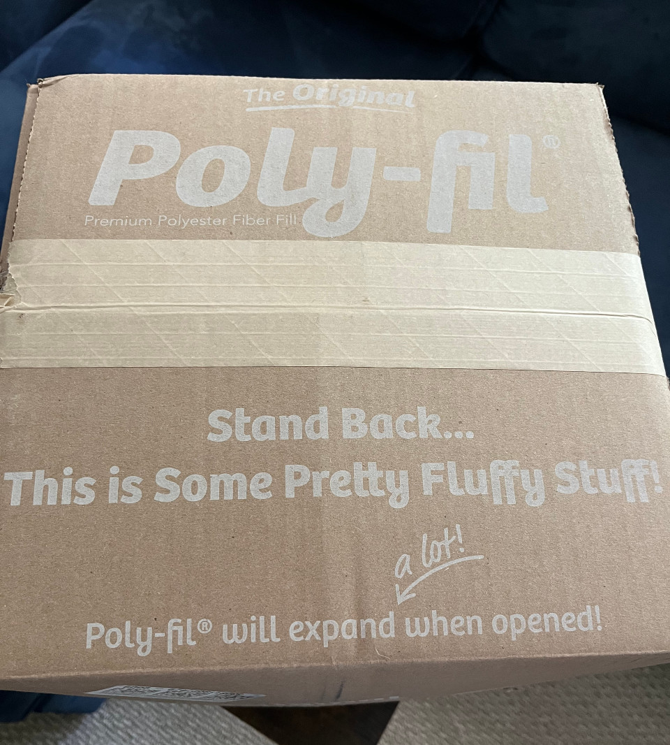 the top of the box with the text "Stand back...This is some pretty Fluffy Stuff! Poly-fil will expand a lot when opened!"