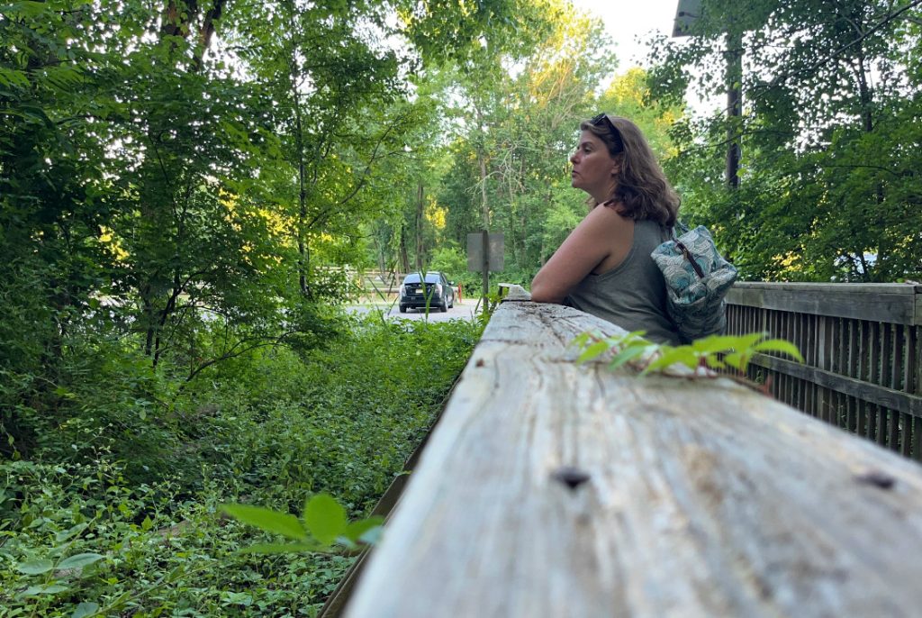 kim staring into a woodsy area. this photo was taken with a photo timer so it looks candid but it in fact quite planed and posed.