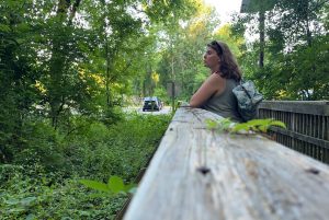 kim staring into a woodsy area. this photo was taken with a photo timer so it looks candid but it in fact quite planed and posed.