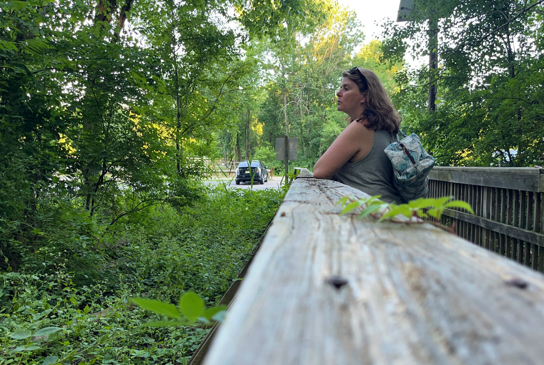 kim staring into a woodsy area. this photo was taken with a photo timer so it looks candid but it in fact quite planed and posed.